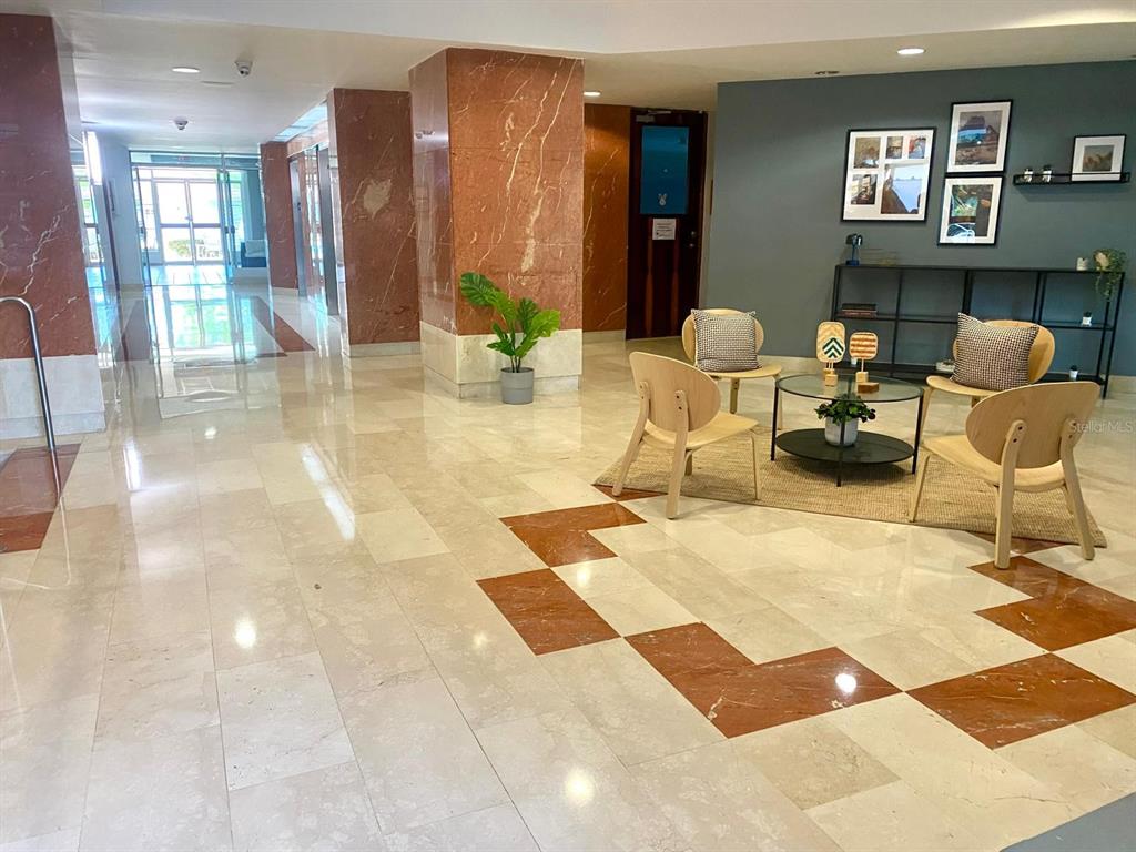 A lobby area features marble floors, red marble columns, and a seating area with chairs — 155 CARAZO ST. CONDO. REGENCY PARK UNIT 17-C, GUAYNABO, PR