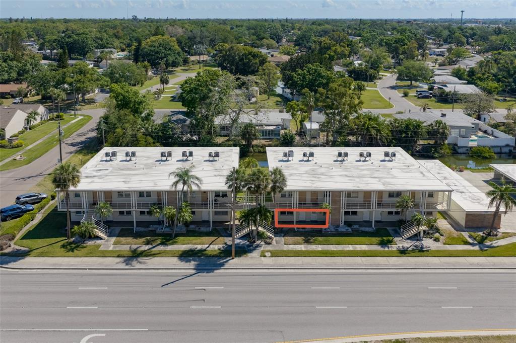 An aerial view shows two adjacent apartment buildings with a highlighted ground-floor unit — 4565 DUHME ROAD UNIT 106, MADEIRA BEACH, FL