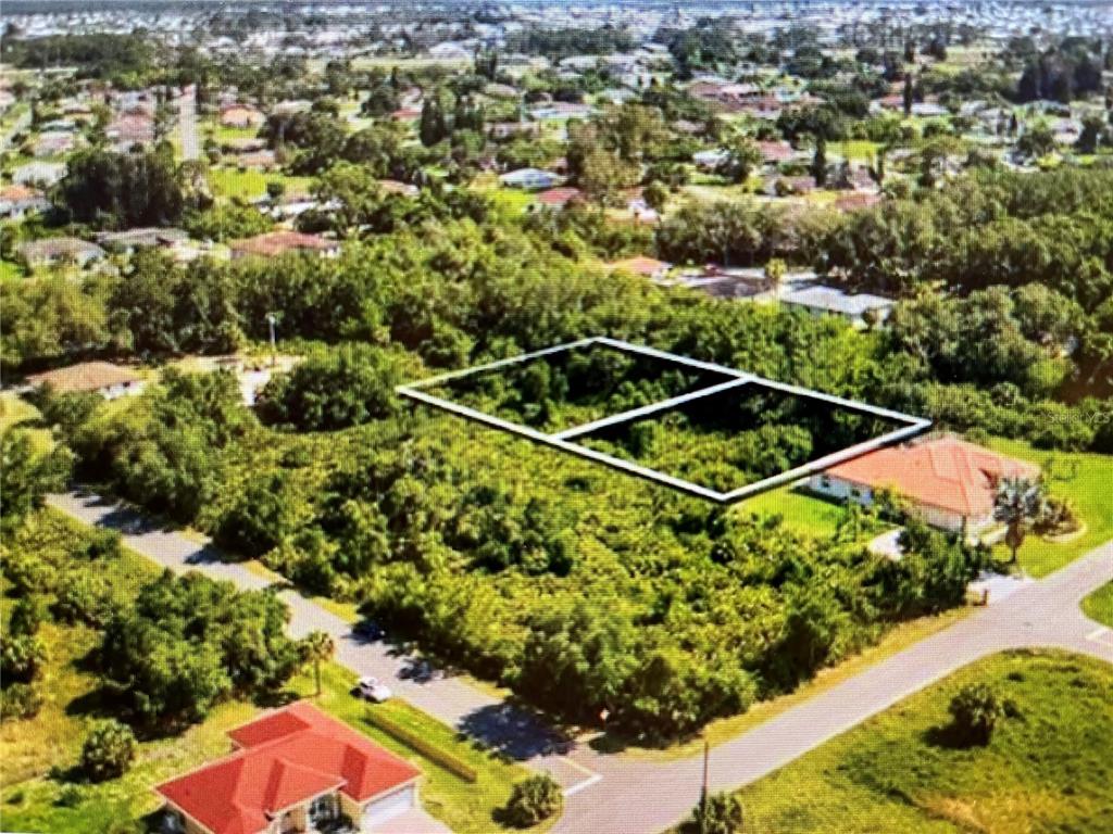 An aerial view shows two adjacent, undeveloped, tree-covered lots outlined in white in a neighborhood — LOT 8 DOLORES STREET, NORTH PORT, FL