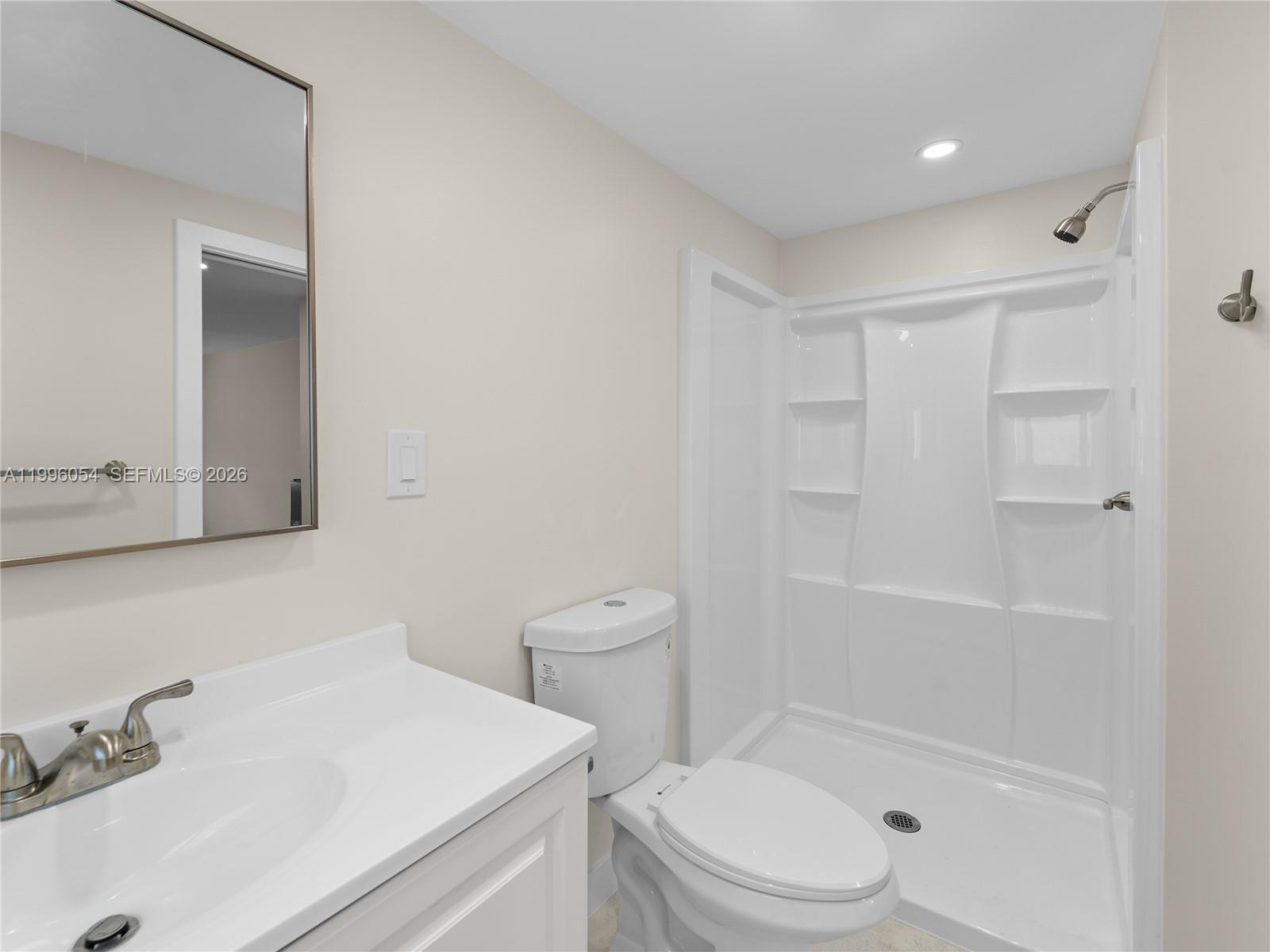 A bathroom features a white vanity, a toilet, and a walk-in shower stall — 7401 SW 38th St # A, Miami FL 33155, MIAMI, FL