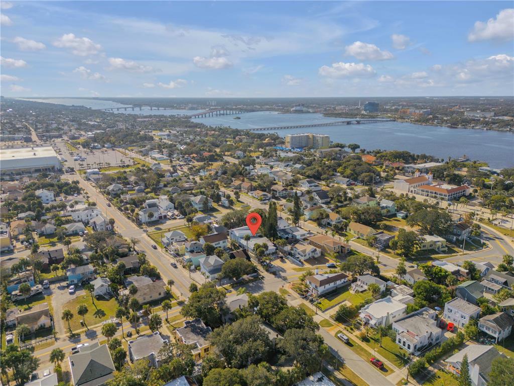 An aerial view shows a residential neighborhood near a large body of water — 410 BUTLER BOULEVARD, DAYTONA BEACH, FL