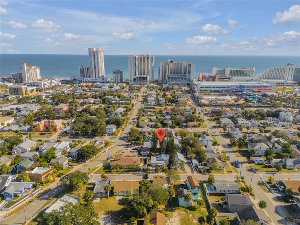 An aerial view shows a residential neighborhood near a beach with high-rise hotels — 410 BUTLER BOULEVARD, DAYTONA BEACH, FL