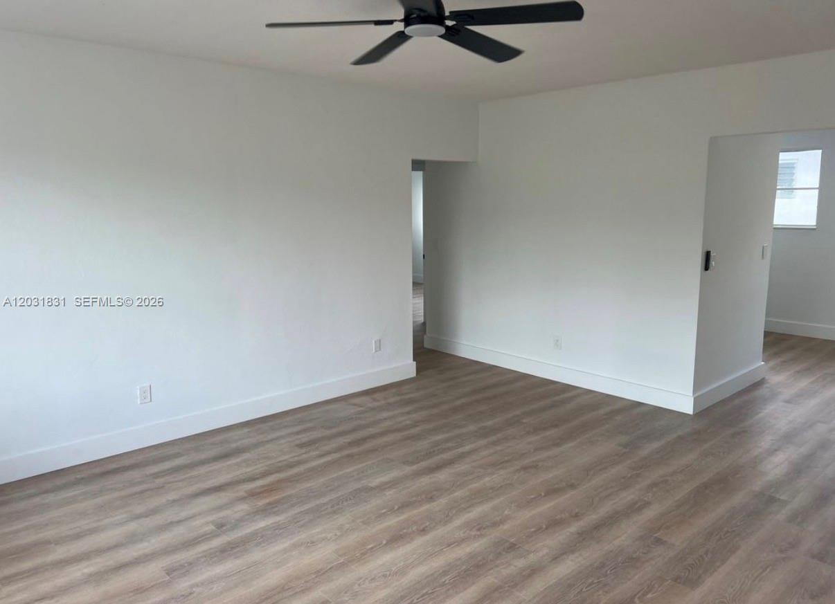 An empty room with white walls, light wood-look flooring, and a ceiling fan — 7730 Byron Ave # 4, Miami Beach FL 33141, MIAMI BEACH, FL