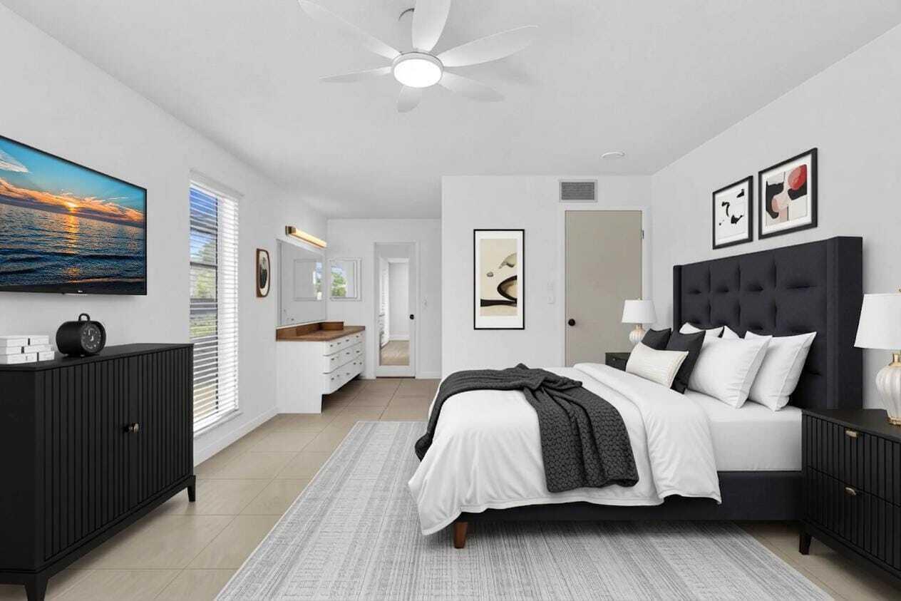A modern bedroom features a black tufted headboard, matching furniture, and an attached vanity area — 13721 Flora Place # D, Delray Beach FL 33484, DELRAY BEACH, FL