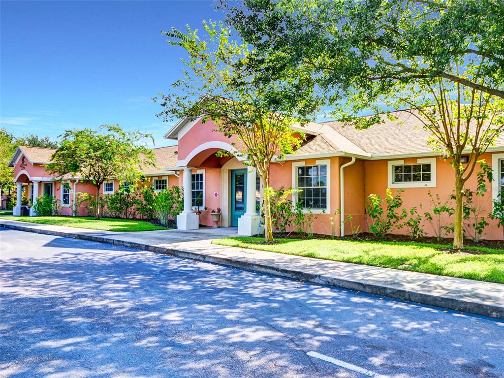 A single-story peach-colored commercial building with a teal front door and arched entryway — 733 S GOLDENROD ROAD, ORLANDO, FL
