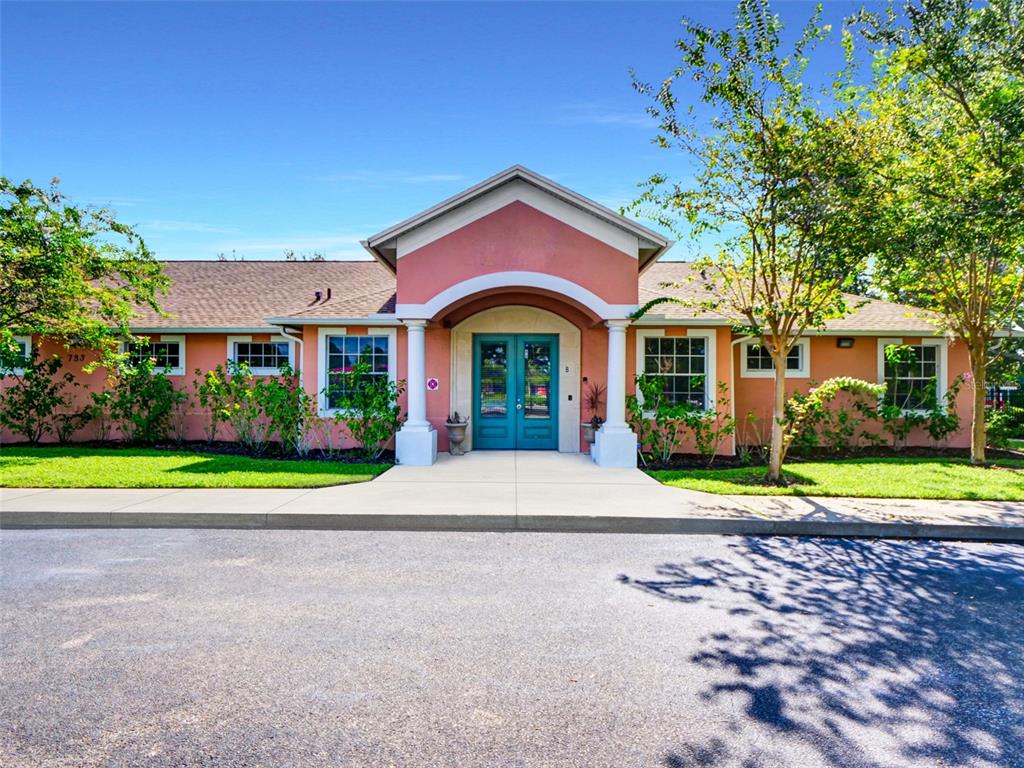 A single-story pink building with a central arched entryway and double doors — 733 S GOLDENROD ROAD, ORLANDO, FL