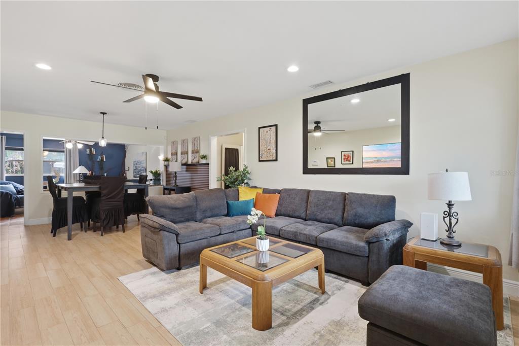 A living room features a large gray sectional sofa, a wooden coffee table, and tile flooring — 2341 DEVON COURT, WINTER PARK, FL