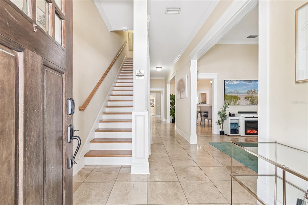 The entryway features a tiled floor, a wooden staircase, and an open view into rooms — 509 S WILLOW AVENUE UNIT 1, TAMPA, FL
