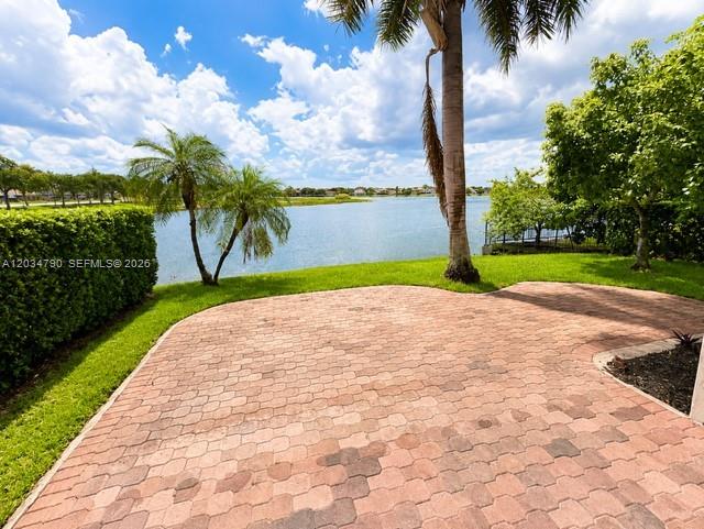 A paved patio overlooks a lake surrounded by palm trees and green landscaping — 5420 SW 134th Ave # 0, Miramar FL 33027, MIRAMAR, FL