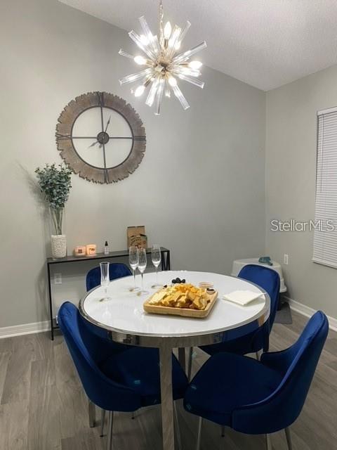 A dining room features a white round table, blue velvet chairs, and a sputnik chandelier — 10000 SW 52ND AVENUE UNIT 158, GAINESVILLE, FL
