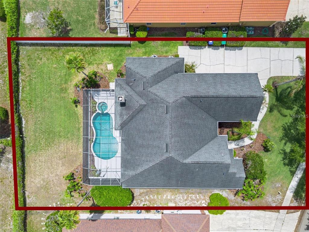 A single-story house with a beige exterior, green shutters, and a cracked concrete driveway — 3865 WINDING LAKE CIRCLE, ORLANDO, FL
