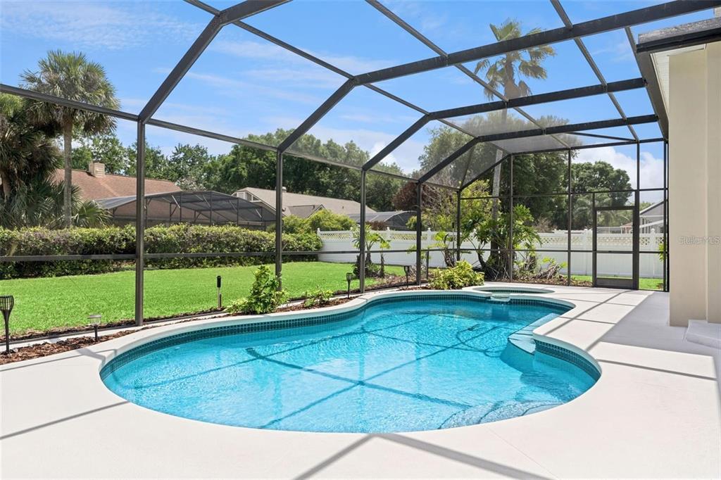 A high-ceilinged foyer and dining area with tile flooring, carpet, and a chandelier — 3865 WINDING LAKE CIRCLE, ORLANDO, FL