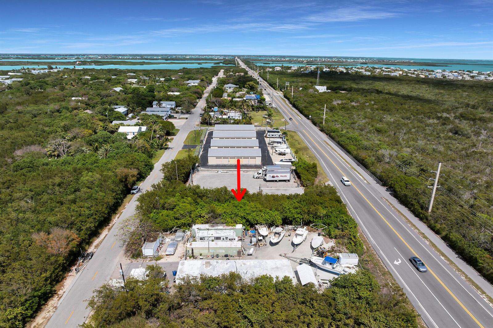 An aerial view shows a commercial property with storage buildings and a boat yard — 26837 Overseas Highway, FL 33042, FL