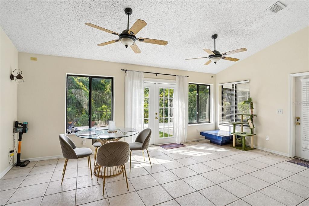 A dining area with tile floors, two ceiling fans, and glass doors leading outside — 1167 WOODLAND TERRACE TRAIL, ALTAMONTE SPRINGS, FL