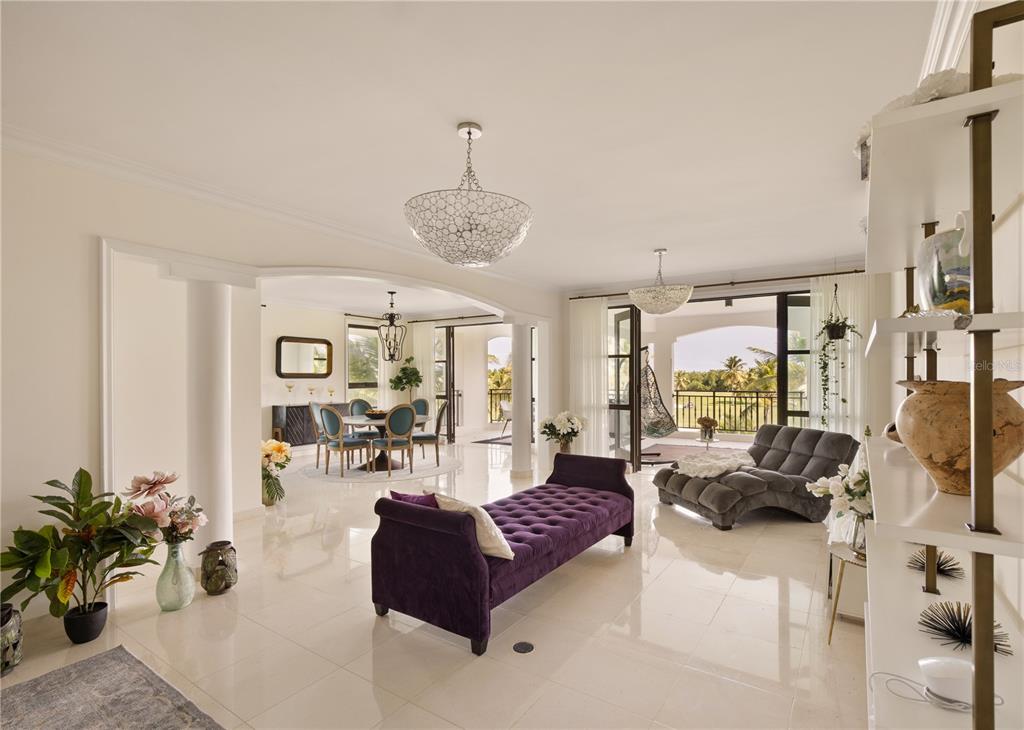 A bright living and dining area features white tile floors, a purple chaise, and balcony — 400 COCO BEACH UNIT 301, RIO GRANDE, PR