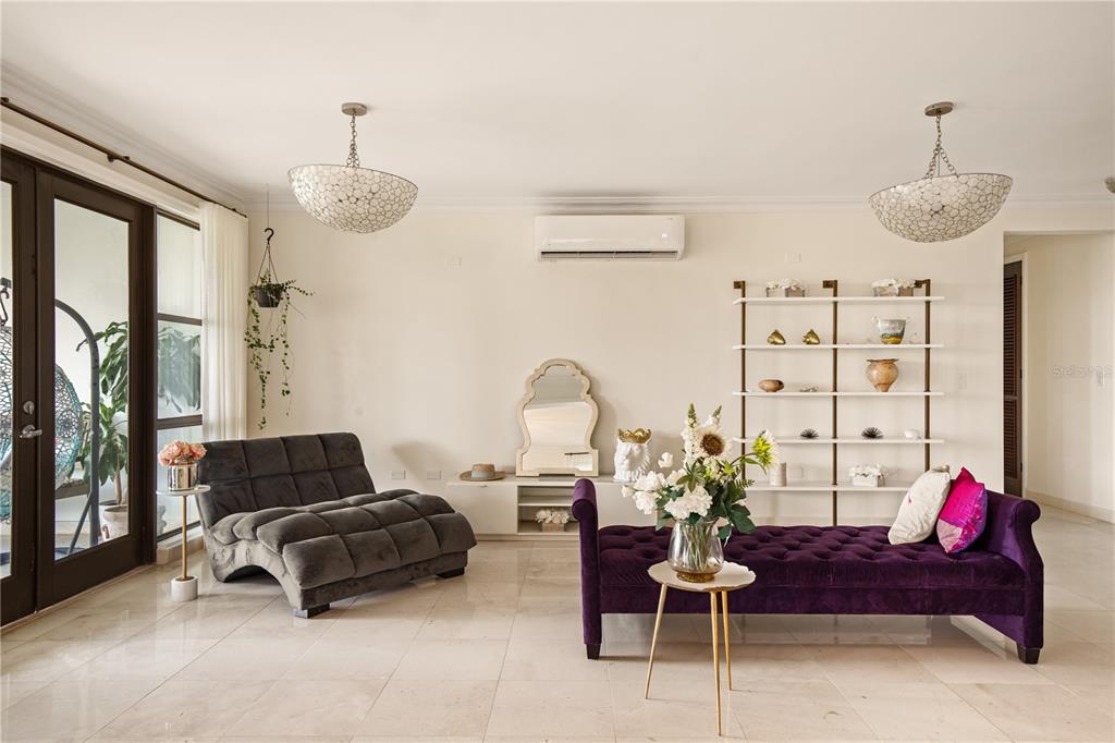A living room features a grey lounge chair, a purple tufted bench, and white shelving — 400 COCO BEACH UNIT 301, RIO GRANDE, PR