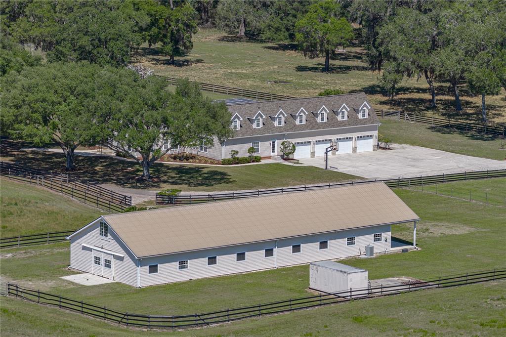 An aerial view shows a house with a multi-car garage and a separate barn — 29001 BAYHEAD ROAD, DADE CITY, FL