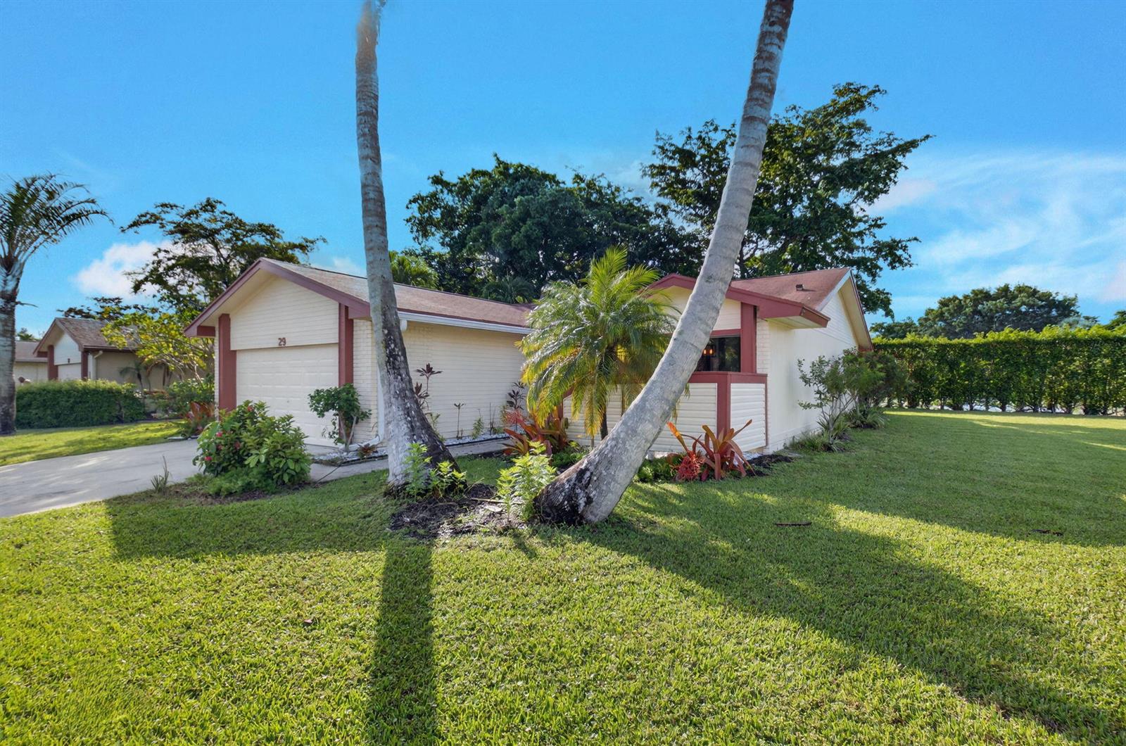 An aerial view shows a residential house with a red roof next to tennis courts — 29 Fawlkland Circle, Boynton Beach FL 33426, BOYNTON BEACH, FL