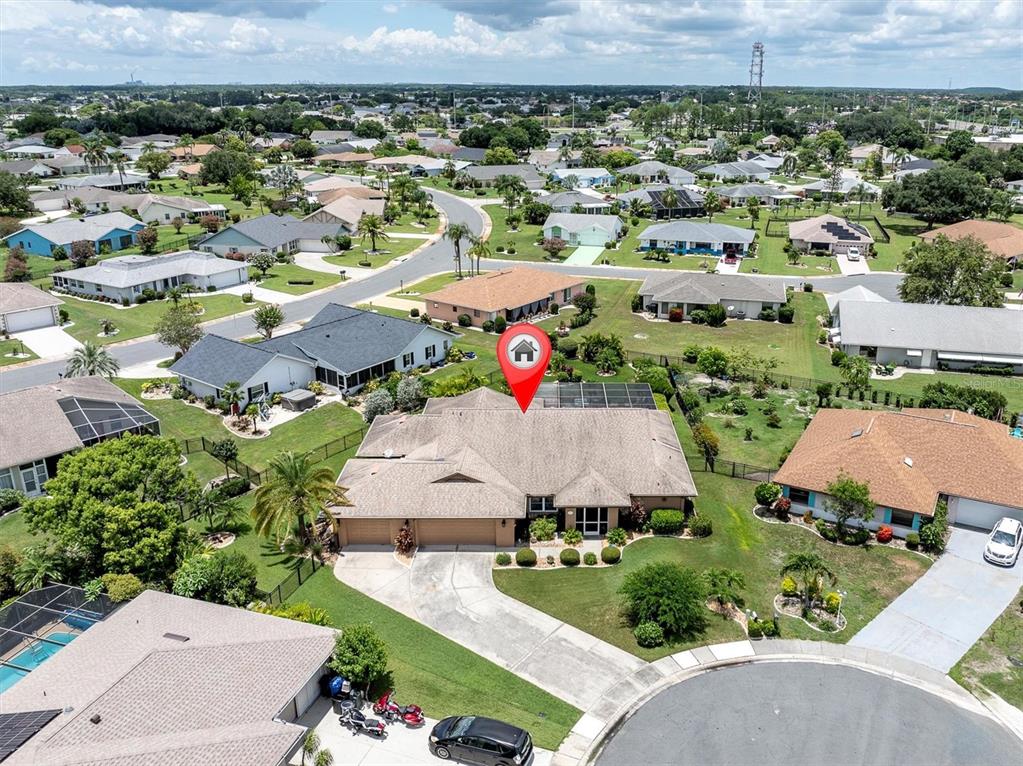 An aerial view of a suburban residential neighborhood featuring a single-story house with a pool — 301 THORN HILL PLACE, SUN CITY CENTER, FL