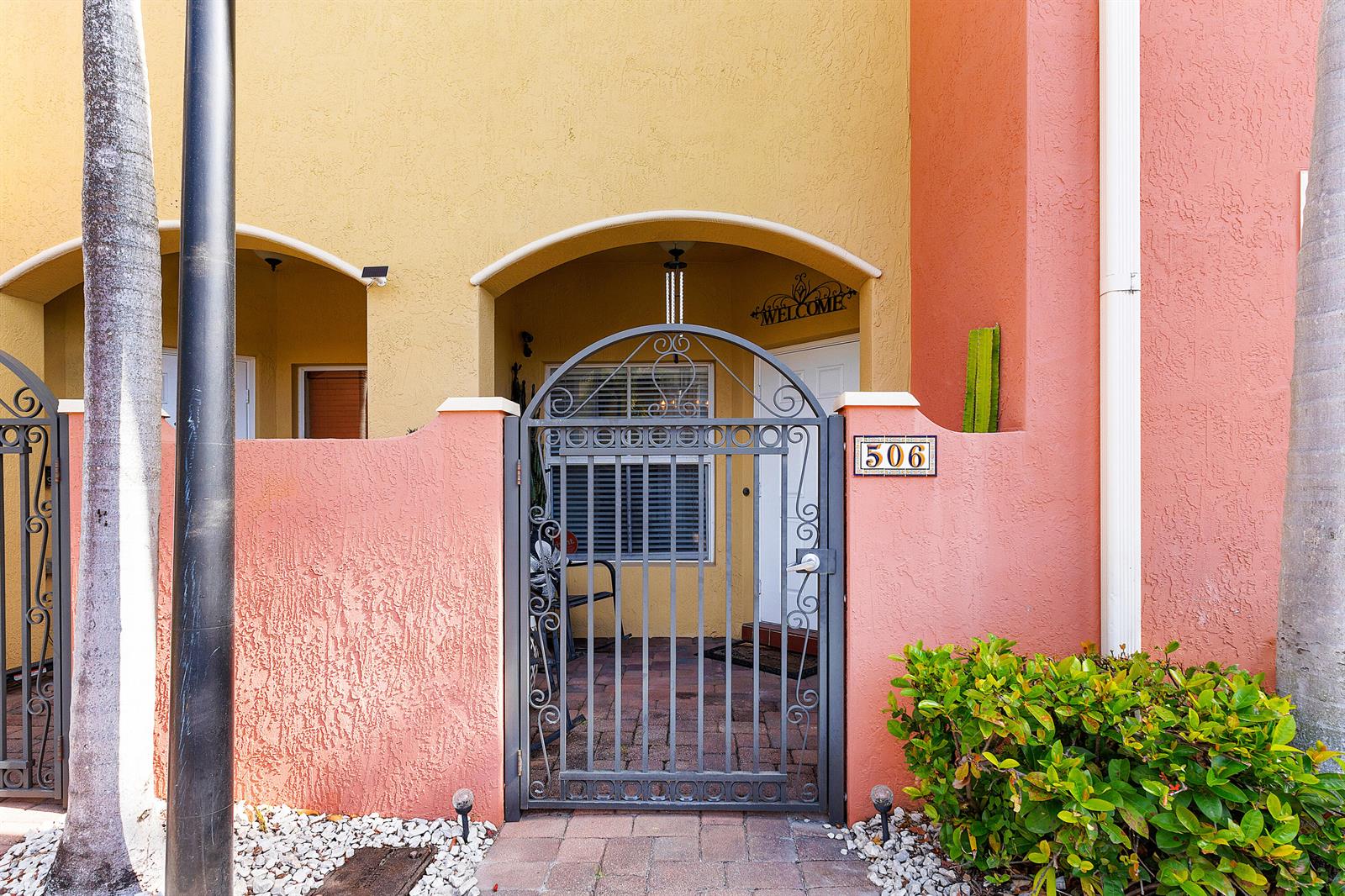 A gated entrance leads to a patio with a front door and a house number — 2851 W Prospect # 506, Tamarac FL 33309, TAMARAC, FL