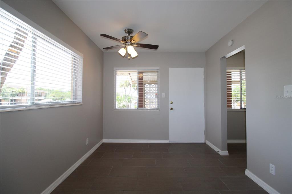 A room with gray walls, tile flooring, a ceiling fan, and two windows — 3001 BEE RIDGE ROAD UNIT 224, SARASOTA, FL