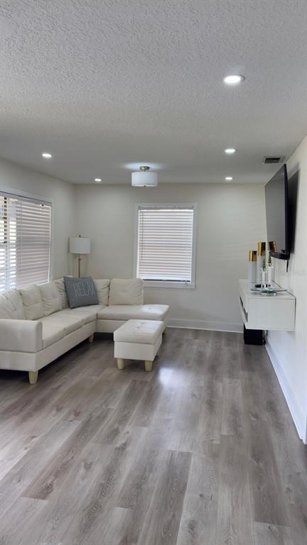 A tan, single-story house with a covered front porch and a concrete walkway — 2109 E NAVAJO AVENUE, TAMPA, FL