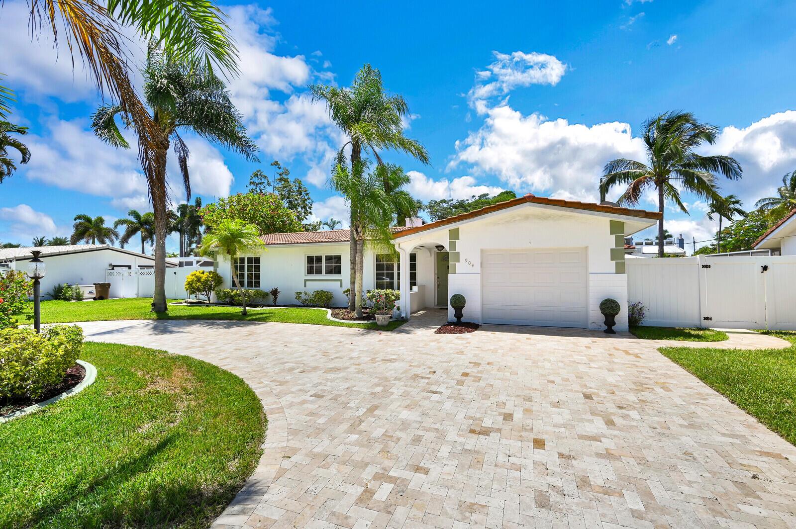 A single-story white house with a paved driveway, palm trees, and a garage — 904 SE 12th Street, Deerfield Beach FL 33441, DEERFIELD BEACH, FL