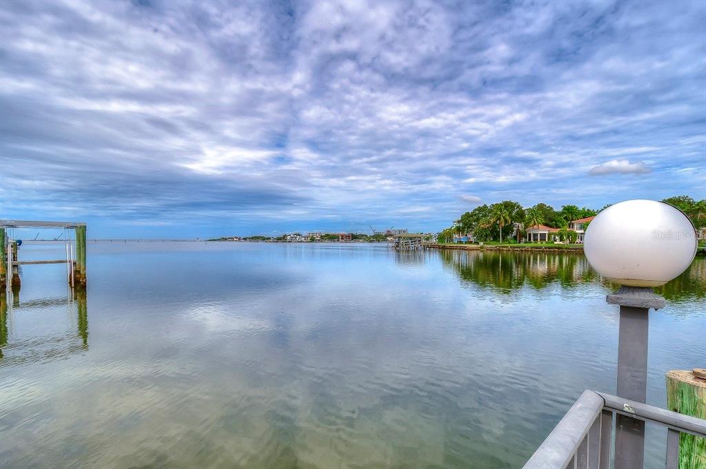 A view of a calm bay from a wooden dock with a round lamp — 4929 W BAY WAY DRIVE, TAMPA, FL