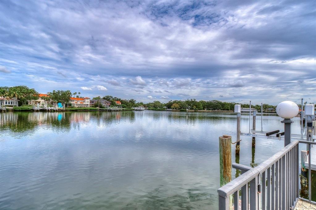 A view of a calm waterway from a private dock with a boat lift — 4929 W BAY WAY DRIVE, TAMPA, FL