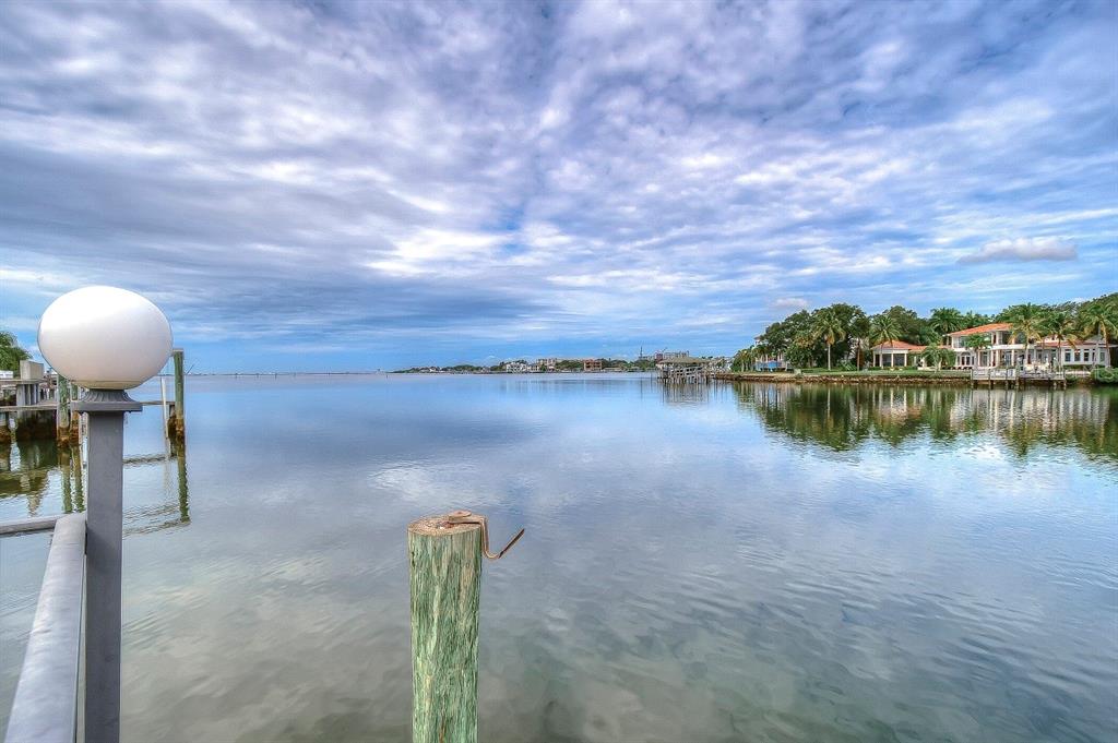 A view of a calm bay from a wooden dock with a lamp post — 4929 W BAY WAY DRIVE, TAMPA, FL