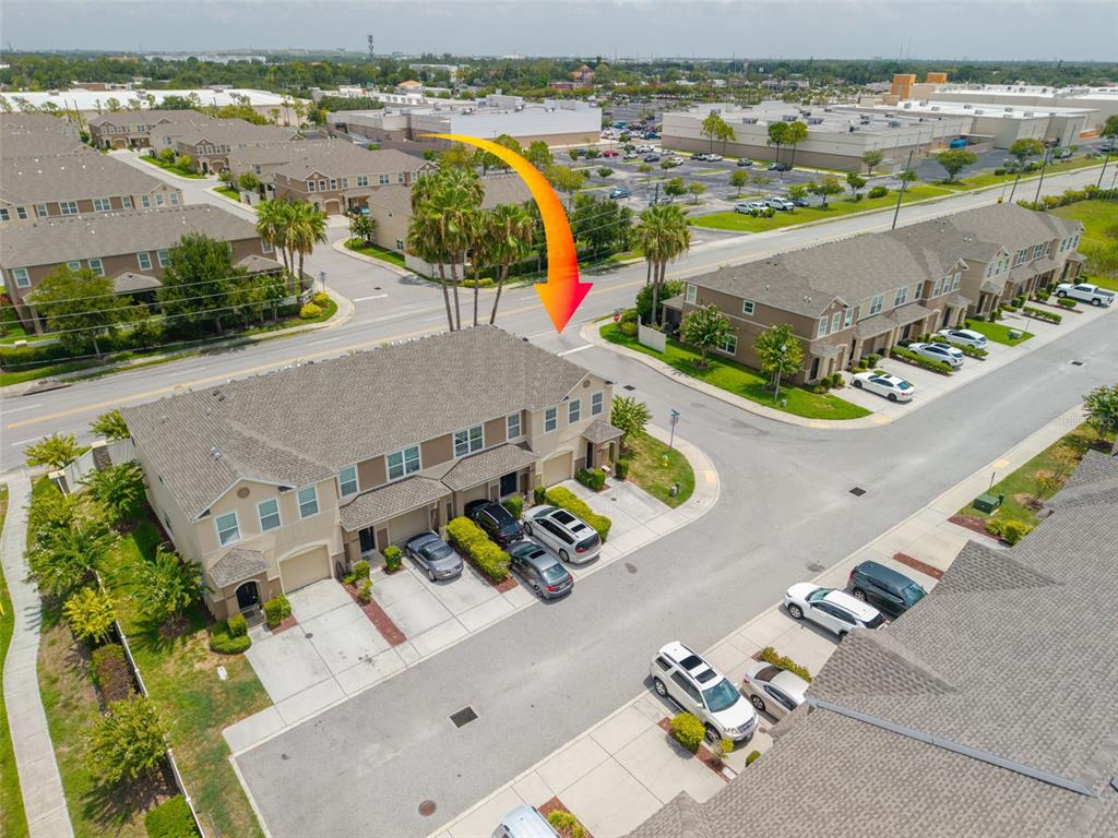 An aerial view shows a multi-unit townhouse complex with parking spaces and surrounding residential streets — 4087 69TH TERRACE N, PINELLAS PARK, FL