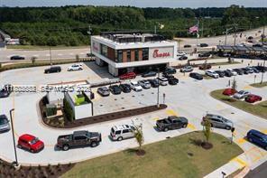 An aerial view shows a Chick-fil-A restaurant with a drive-thru lane and parking lot — 721 W Hallandale Beach Blvd, Hallandale Beach FL 33009, HALLANDALE BEACH, FL