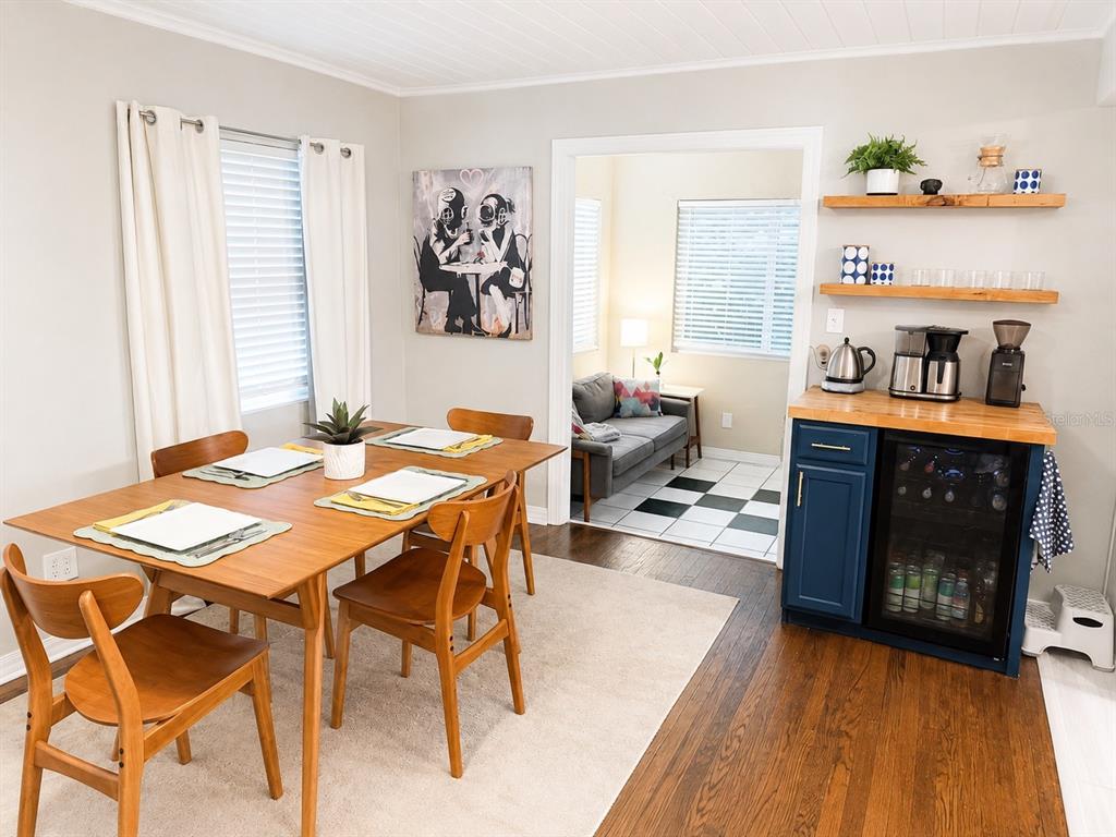 A dining room features a wooden table, four chairs, a coffee station, and an adjacent room — 926 29TH STREET N, ST PETERSBURG, FL