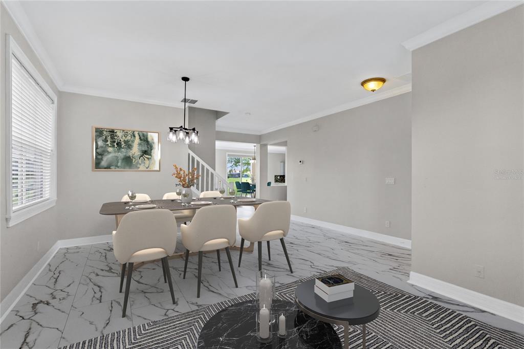 A dining area with a table, chairs, and marble-look tile flooring in a staged home — 10408 CHORLTON CIRCLE, ORLANDO, FL