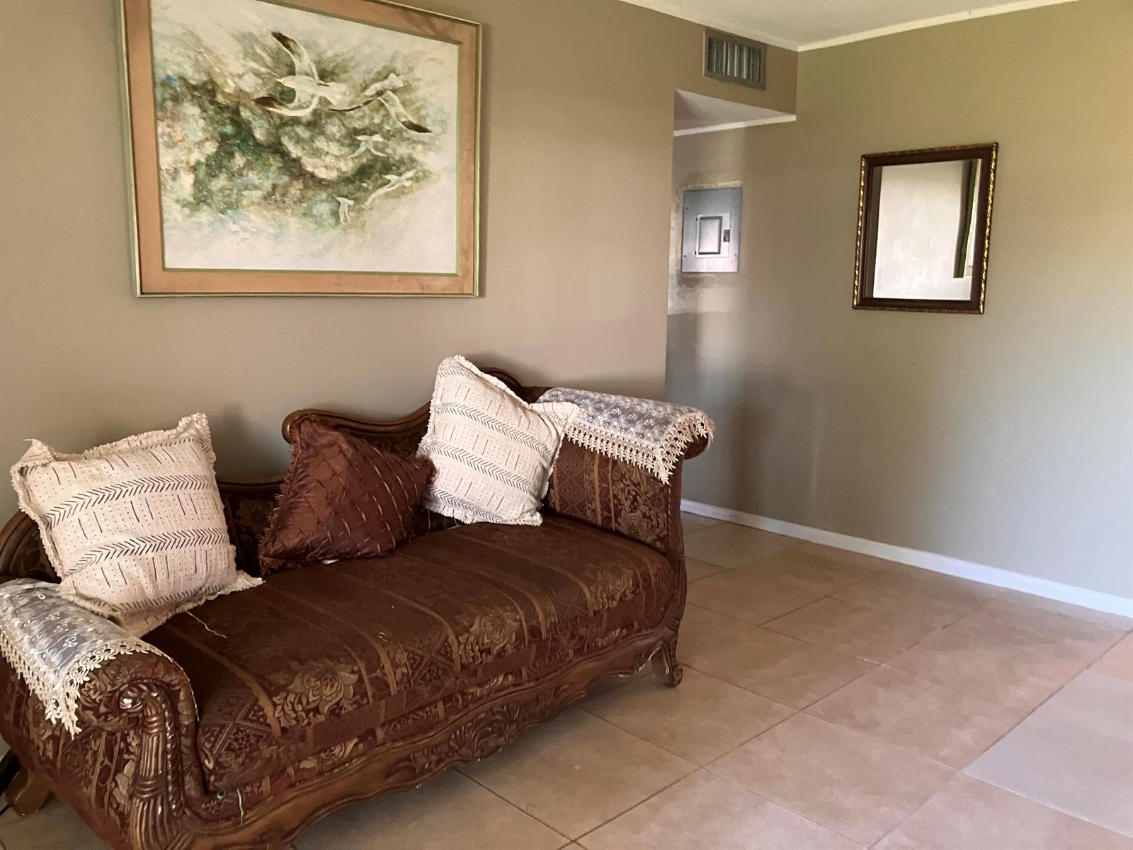 A brown ornate chaise lounge sits in a room with beige walls and tiled floors — 17 Golfs Edge # D, West Palm Beach FL 33417, WEST PALM BEACH, FL