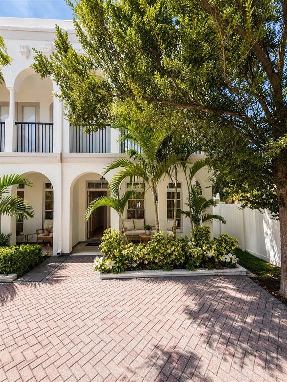A white two-story building with arched entryways, a brick driveway, and lush landscaping — 630 3RD AVENUE S, ST PETERSBURG, FL
