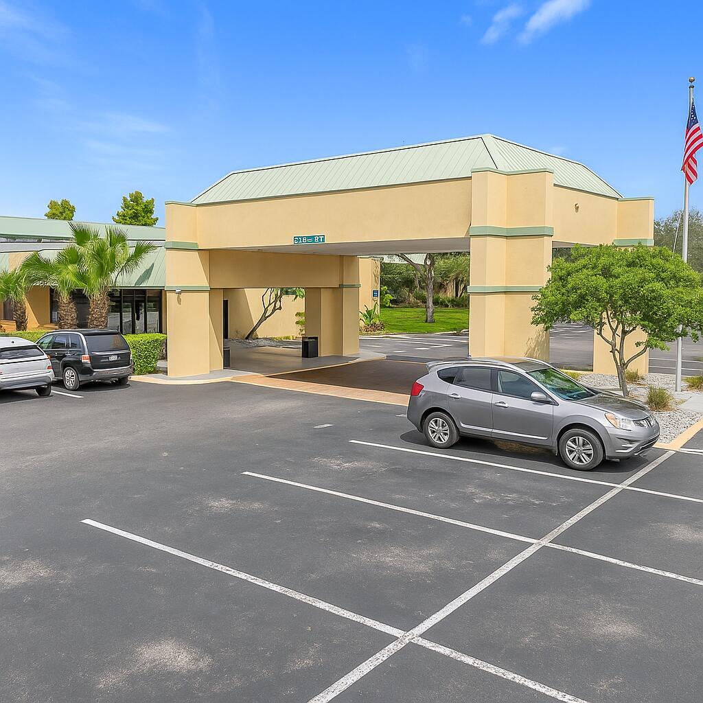 An exterior view of a building entrance with a covered driveway and a parking lot — 910 Suemac Road, Jacksonville FL 32254, JACKSONVILLE, FL
