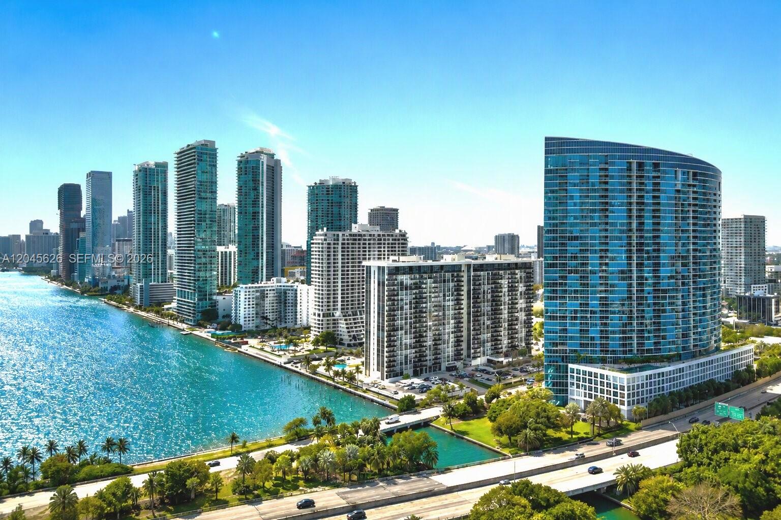 An aerial view of a waterfront city skyline featuring numerous high-rise residential buildings — 601 NE 36th St # 3011, Miami FL 33137, MIAMI, FL