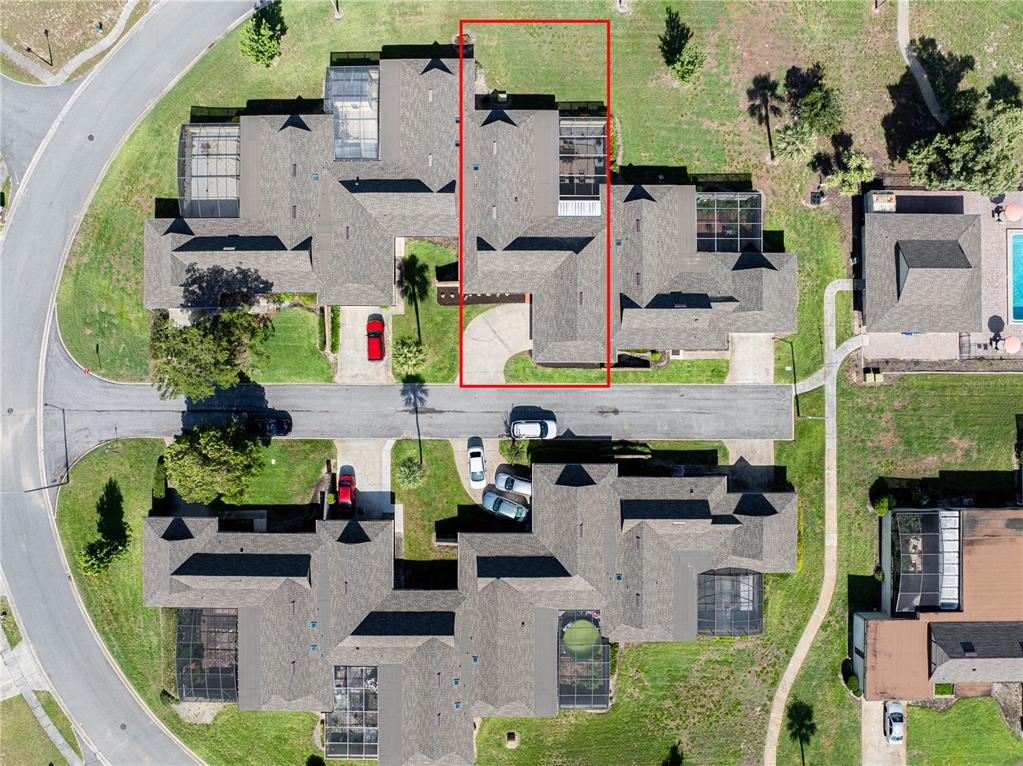 This aerial view shows a residential townhouse complex with a red box highlighting one unit — 1408 MAGELLAN CIRCLE UNIT 103, ORLANDO, FL