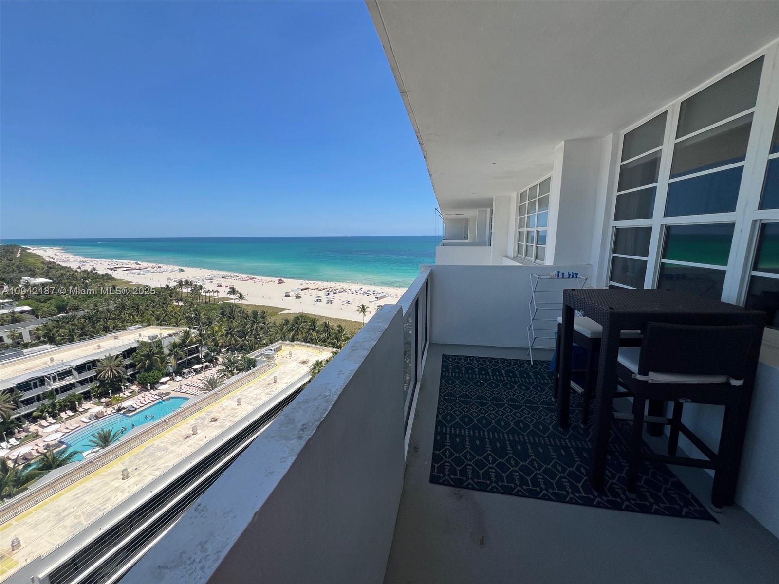 A high-rise balcony overlooks a beach, ocean, and a swimming pool below — 100 Lincoln Rd # 1637, Miami Beach FL 33139, MIAMI BEACH, FL