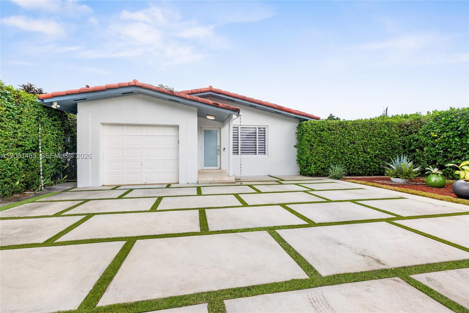 A single-story house features a white exterior, a tiled roof, and a paved driveway — 2121 Red Rd # 0, Coral Gables FL 33155, CORAL GABLES, FL