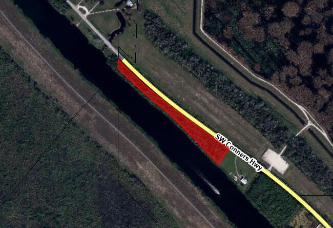 This map shows a highlighted parcel of land situated between a canal and a highway — 7150 SW Conners Highway, Okeechobee FL 34974, OKEECHOBEE, FL