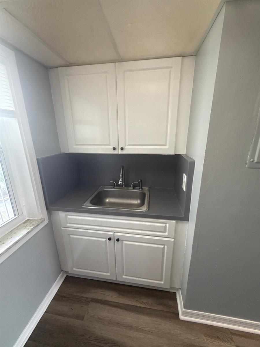 A small kitchenette features white cabinets, a gray countertop, and a stainless steel sink — 2605 NW 135th Street # 309, Opa-Locka FL 33167, OPA-LOCKA, FL