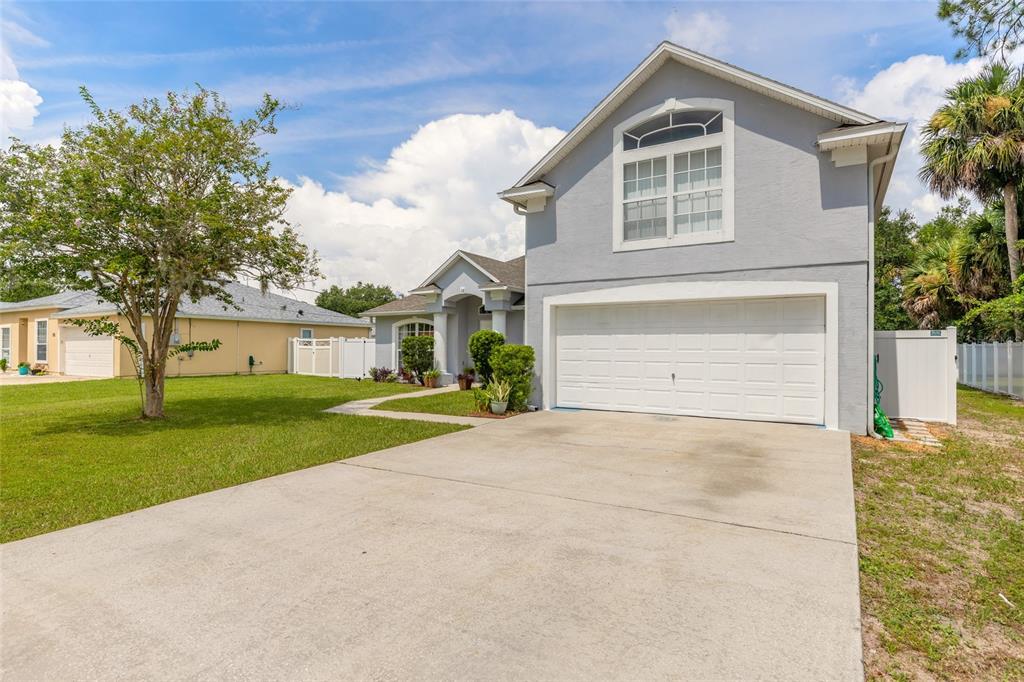 A two-story gray house with a two-car garage and a concrete driveway — 28 PILLORY LANE, PALM COAST, FL