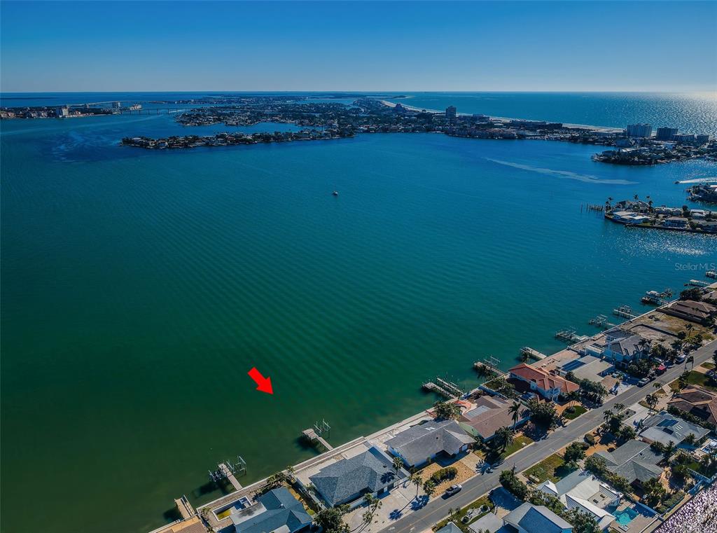 An aerial view of a waterfront property with a private dock extending into the bay — 510 55TH AVENUE, ST PETE BEACH, FL
