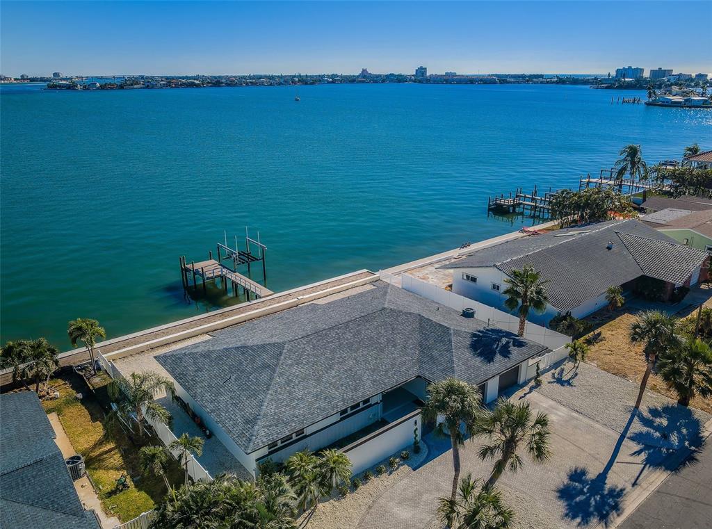 An aerial view of a waterfront house with a private dock and a shingled roof — 510 55TH AVENUE, ST PETE BEACH, FL