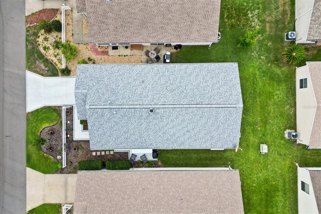 An aerial view shows a residential house with a gray shingled roof and surrounding lawn — 3541 ROANOKE STREET, THE VILLAGES, FL