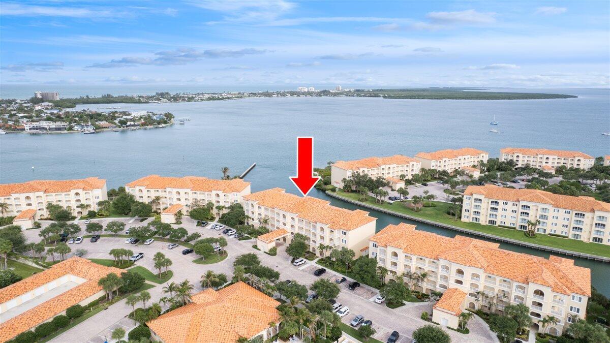 An aerial view shows a multi-story residential building complex with terracotta roofs near water — 5 E Harbour Isle Dr Drive E # 103, Fort Pierce FL 34949, FORT PIERCE, FL