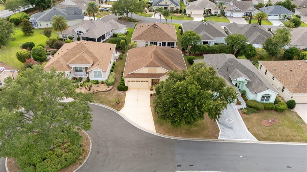 An aerial view shows several suburban houses with driveways and landscaping in a residential neighborhood — 1570 GIFFORD COURT, THE VILLAGES, FL