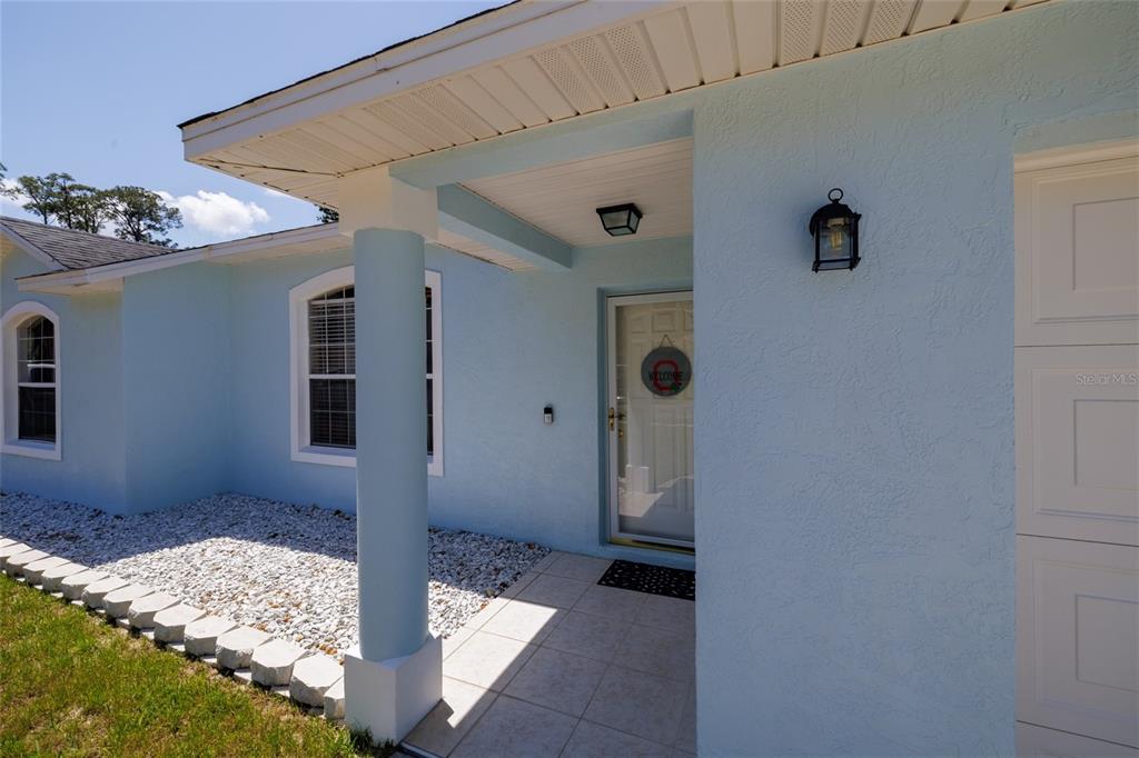 A light blue single-story house with a two-car garage and a concrete driveway — 2980 WINDLE LANE, SOUTH DAYTONA, FL